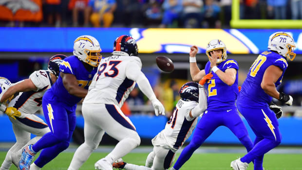 Denver Broncos safety Justin Simmons (31) forces Los Angeles Chargers quarterback Easton Stick (2) to turn the ball over during the second half at SoFi Stadium.